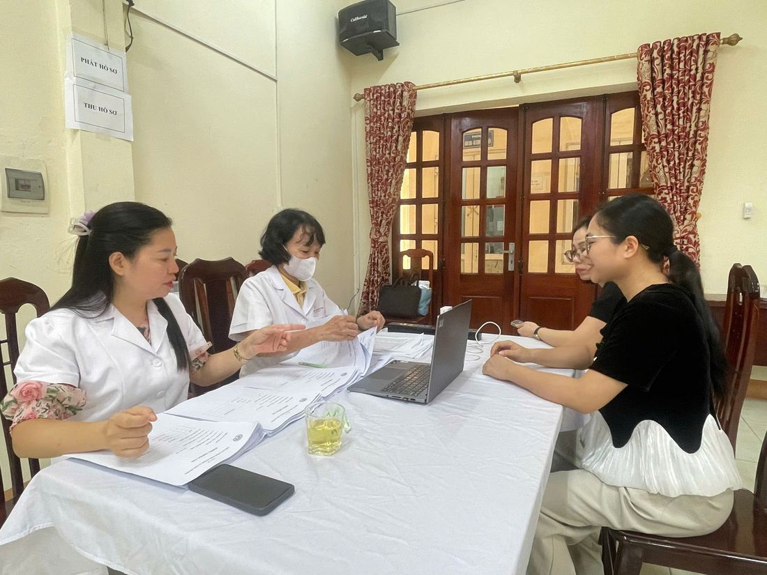 Cán bộ y tế phỏng vấn giáo viên phục vụ đánh giá tình trạng rối loạn giọng nói.